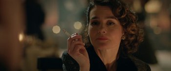 Movie still from “Stan & Ollie” (2018), directed by Jon S. Baird – A person holding a cigarette in her hand; Close Up shot, Over the shoulder angle