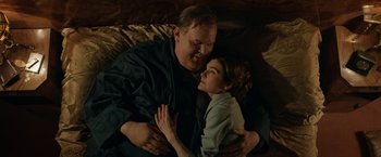 Movie still from “Stan & Ollie” (2018), directed by Jon S. Baird – A man and a woman laying in bed together; Medium shot, Overhead angle