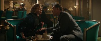 Movie still from “Stan & Ollie” (2018), directed by Jon S. Baird – A man and a woman sitting at a table talking to each other; Medium shot, Over the shoulder angle