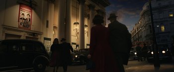 Movie still from “Stan & Ollie” (2018), directed by Jon S. Baird – A group of people standing in front of a building at night; Extreme Wide shot, Low angle