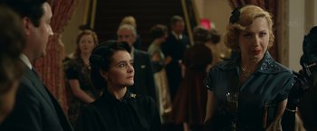 Movie still from “Stan & Ollie” (2018), directed by Jon S. Baird – A group of people standing in a room; Medium shot, Over the shoulder angle