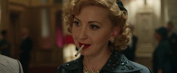 Movie still from “Stan & Ollie” (2018), directed by Jon S. Baird – A woman with a cigarette in her mouth; Close Up shot, Over the shoulder angle