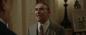 Movie still from “Stan & Ollie” (2018), directed by Jon S. Baird – An older man wearing a suit and tie; Close Up shot, Low angle