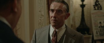 Movie still from “Stan & Ollie” (2018), directed by Jon S. Baird – An older man wearing a suit and tie; Close Up shot, Low angle