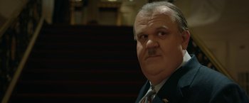 Movie still from “Stan & Ollie” (2018), directed by Jon S. Baird – An older man with a mustache and a suit and tie; Close Up shot, Low angle