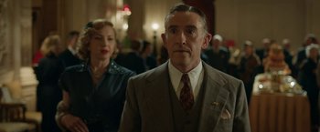 Movie still from “Stan & Ollie” (2018), directed by Jon S. Baird – A man in a suit and tie next to a woman in a dress; Medium shot, Low angle