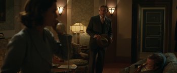 Movie still from “Stan & Ollie” (2018), directed by Jon S. Baird – A man in a suit and tie holding a hat; Medium shot, Low angle