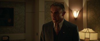 Movie still from “Stan & Ollie” (2018), directed by Jon S. Baird – A man in a suit and tie standing in a room; Close Up shot, Low angle