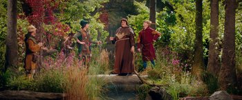 Movie still from “Stan & Ollie” (2018), directed by Jon S. Baird – A group of people dressed in medieval costumes; Wide shot, Over the shoulder angle