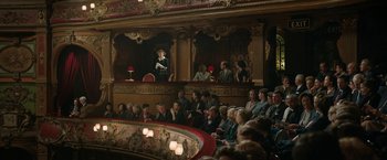 Movie still from “Stan & Ollie” (2018), directed by Jon S. Baird – A group of people sitting on a stage in a theater; Extreme Wide shot, High angle