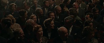 Movie still from “Stan & Ollie” (2018), directed by Jon S. Baird – A group of people sitting in a room; Medium shot, High angle