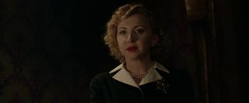 Movie still from “Stan & Ollie” (2018), directed by Jon S. Baird – A woman wearing a black and white suit and a pearl necklace; Close Up shot, Low angle