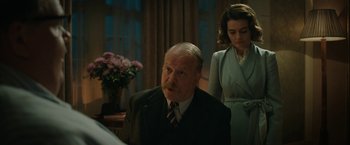 Movie still from “Stan & Ollie” (2018), directed by Jon S. Baird – An older man in a suit and tie next to an older woman; Medium shot, Low angle