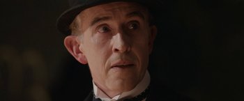 Movie still from “Stan & Ollie” (2018), directed by Jon S. Baird – An older man wearing a black hat and a black suit; Close Up shot, Low angle