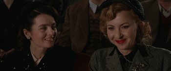 Movie still from “Stan & Ollie” (2018), directed by Jon S. Baird – Two women sitting next to each other in front of a crowd; Close Up shot, Over the shoulder angle