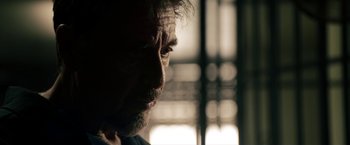 Movie still from “Stand Up Guys” (2012), directed by Fisher Stevens – A man's face in the dark; Close Up shot, Low angle