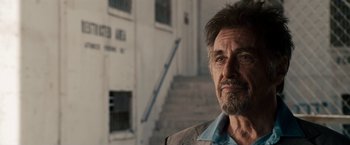 Movie still from “Stand Up Guys” (2012), directed by Fisher Stevens – A person wearing a suit and tie; Close Up shot, Over the shoulder angle