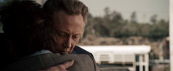 Movie still from “Stand Up Guys” (2012), directed by Fisher Stevens – A person wearing a suit and tie; Close Up shot, Over the shoulder angle