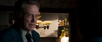 Movie still from “Stand Up Guys” (2012), directed by Fisher Stevens – A person wearing a suit and tie; Close Up shot, Over the shoulder angle