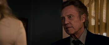 Movie still from “Stand Up Guys” (2012), directed by Fisher Stevens – A person wearing a suit and tie; Close Up shot, Over the shoulder angle