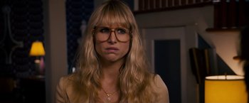 Movie still from “Stand Up Guys” (2012), directed by Fisher Stevens – A woman with long blonde hair wearing glasses; Close Up shot, Over the shoulder angle