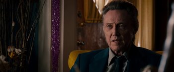 Movie still from “Stand Up Guys” (2012), directed by Fisher Stevens – An older man wearing a suit sitting in a chair; Close Up shot, Over the shoulder angle