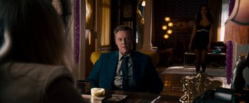 Movie still from “Stand Up Guys” (2012), directed by Fisher Stevens – A man sitting at a table in a room; Medium shot, Over the shoulder angle