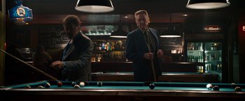 Movie still from “Stand Up Guys” (2012), directed by Fisher Stevens – Two men in suits playing pool in a bar; Medium shot, Over the shoulder angle