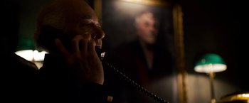 Movie still from “Stand Up Guys” (2012), directed by Fisher Stevens – A man talking on a phone in front of a mirror; Close Up shot, Low angle