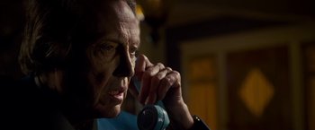 Movie still from “Stand Up Guys” (2012), directed by Fisher Stevens – An older man talking on a phone while sitting in a chair; Close Up shot, Low angle