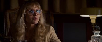 Movie still from “Stand Up Guys” (2012), directed by Fisher Stevens – A woman with blonde hair and glasses sitting in a chair; Close Up shot, Over the shoulder angle