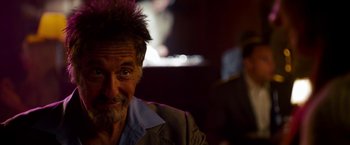 Movie still from “Stand Up Guys” (2012), directed by Fisher Stevens – An older man with a beard and a mustache; Close Up shot, Over the shoulder angle