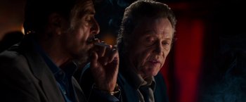 Movie still from “Stand Up Guys” (2012), directed by Fisher Stevens – A man smoking a cigarette next to another man in a suit; Close Up shot, Over the shoulder angle