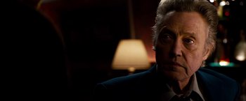 Movie still from “Stand Up Guys” (2012), directed by Fisher Stevens – A person wearing a suit and tie; Close Up shot, Over the shoulder angle