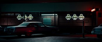 Movie still from “Stand Up Guys” (2012), directed by Fisher Stevens – A car parked in front of a building at night; Wide shot, Low angle