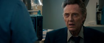 Movie still from “Stand Up Guys” (2012), directed by Fisher Stevens – An older man wearing a suit and tie in front of an anesthetizer; Close Up shot, Over the shoulder angle