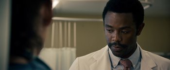 Movie still from “Stand Up Guys” (2012), directed by Fisher Stevens – A man in a white suit looking down at a man in a white suit; Close Up shot, Over the shoulder angle