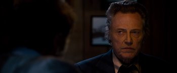 Movie still from “Stand Up Guys” (2012), directed by Fisher Stevens – A person wearing a suit and tie; Close Up shot, Over the shoulder angle