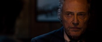 Movie still from “Stand Up Guys” (2012), directed by Fisher Stevens – An older man wearing a suit and tie; Close Up shot, Over the shoulder angle