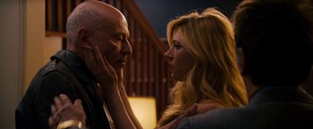 Movie still from “Stand Up Guys” (2012), directed by Fisher Stevens – A man and a woman face to face in front of a staircase; Close Up shot, Low angle