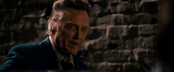 Movie still from “Stand Up Guys” (2012), directed by Fisher Stevens – A person wearing a suit and tie; Close Up shot, Over the shoulder angle