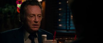 Movie still from “Stand Up Guys” (2012), directed by Fisher Stevens – A person sitting at a table; Close Up shot, Over the shoulder angle