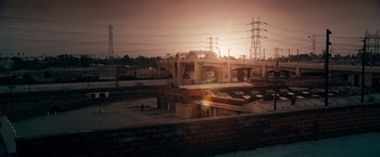 Movie still from “Stand Up Guys” (2012), directed by Fisher Stevens – The sun is setting over a train station; Extreme Wide shot, High angle