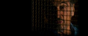 Movie still from “Stand Up Guys” (2012), directed by Fisher Stevens – A man with a goatee looking out of a window; Close Up shot, Low angle