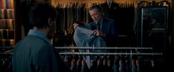 Movie still from “Stand Up Guys” (2012), directed by Fisher Stevens – A man in a suit and tie looking at his cell phone; Medium shot, Over the shoulder angle