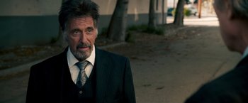 Movie still from “Stand Up Guys” (2012), directed by Fisher Stevens – An older man wearing a suit and tie; Close Up shot, Over the shoulder angle