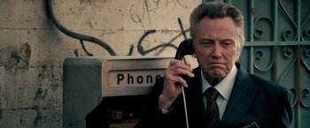 Movie still from “Stand Up Guys” (2012), directed by Fisher Stevens – An older man in a suit and tie holding a phone to his ear; Close Up shot, Low angle