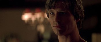 Movie still from “Starman” (1984), directed by John Carpenter – A man's face in the dark; Close Up shot, Over the shoulder angle