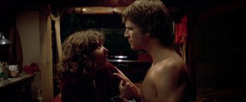 Movie still from “Starman” (1984), directed by John Carpenter – A man and a woman talking to each other; Close Up shot, Low angle