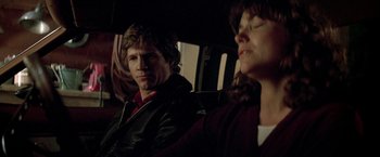 Movie still from “Starman” (1984), directed by John Carpenter – A man and a woman sitting in a car; Close Up shot, Over the shoulder angle